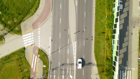 Aerial---following-highway-road-near-Gdynia-Witomino-city,-Poland,-moving-backward-shot