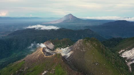 Cinematic-aerial-view-of-the-stratovolcanoes-Mount-Sibayak-and-Mount-Sinabung-in-North-Sumatra,-Indonesia