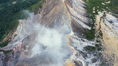 Fly-over-aerial-shot-of-steam-coming-from-the-stratovolcano-Mount-Sibayak-in-North-Sumatra,-Indonesia