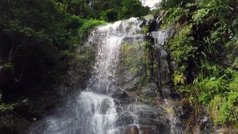 Waterfall-with-fast-current-surrounded-by-lush-green-nature