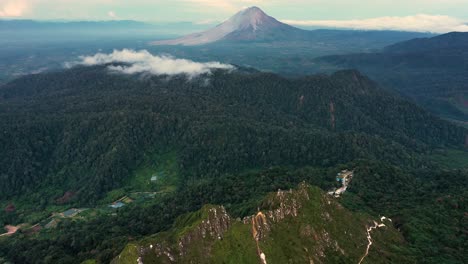 Aerial-view-of-Mount-Sibayak-ridge-tilting-up-to-Mount-Sinabung-in-the-distance---North-Sumatra,-Indonesia