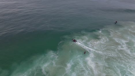 Hydrofoil-Surfer-Being-Pulled-By-A-Boat-In-Sharpes-Beach---Surfing-In-Skennars-Head---NSW,-Australia---aerial-drone