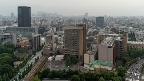 High-above-timelapse-of-Tokyo-skyline-with-skyscrapers-in-distance-and-traffic---push-out-shot