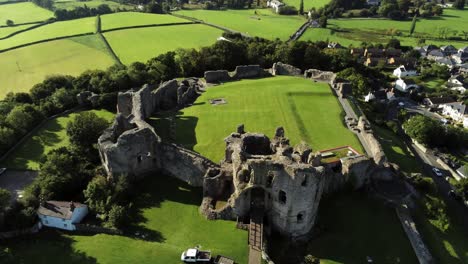 Historic-Wales-landmark-Denbigh-Castle-medieval-old-hill-monument-ruin-tourist-attraction-aerial-view-right-top-down-orbit