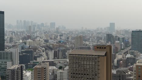 Fast-right-pan-over-Tokyo-skyline-on-gray-and-Hazy-day-with-car-traffic