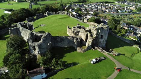 Landmark-ancient-Welsh-Denbigh-Castle-medieval-old-hill-monument-ruin-tourist-attraction-aerial-view