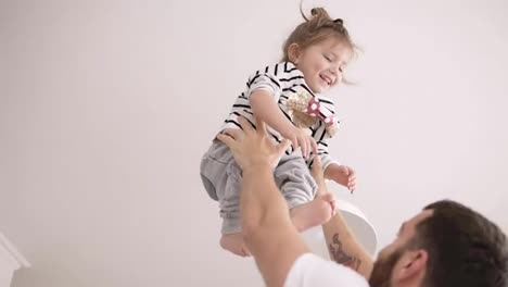 Father-toss-up-his-beautiful-daughter-in-the-air