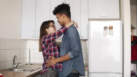 Cute-romantic-couple-dancing-in-a-comfy-cozy-kitchen,-enjoying-living-together,-youth.-Commitment,-relationship-goals.