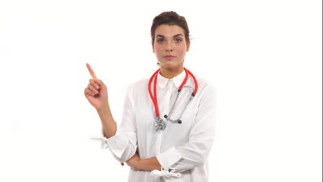 Young-female-doctor-shaking-her-finger-at-the-viewer,-warning-about-a-bad-habit.-Close-up-of-a-female-surgeon-with-stethoscope-and-lab-coat-isolated-on-white-background