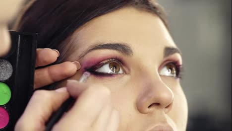 Close-up-footage-of-creating-perfect-smokey-eyes-look.-Beautiful-hazelnut-eyes-of-an-attractive-brunette-girl.