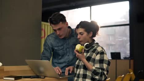 Cute-couple-of-two-young-attractive-people-using-laptop.-Full-concentration.-Spending-time-together.