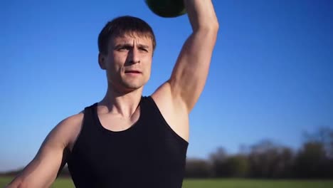 Close-up-footage-of-a-man-exercising-with-weight.-Pumping-hand-muscles.-Caucasian.-Open-area