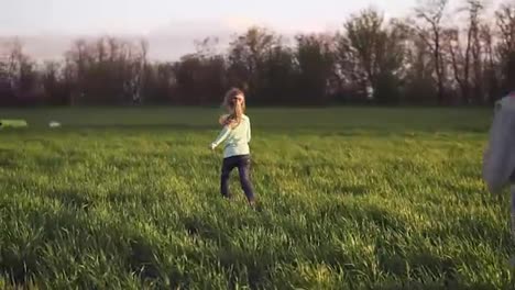Lovely-kids-couple-running-on-a-grass-field.-Slow-motion-shoot-of-a-two-small-sisters-running-happily-on-a-grass-meadow-free-lik-a-bird.-Freely-jumping