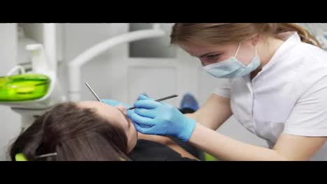 Young-female-dentist-is-examining-patient's-teeth.-Healthy-teeth-and-dental-healthcare.