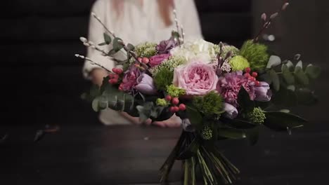 A-survey-slow-motion-footage-of-an-amazing-bouquet-of-flowers-arranged-by-a-florist.-Blurred-background