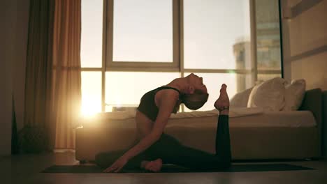 Pigeon-pose.-Attractive-caucasian-woman-practicing-yoga-at-home,-sitting-on-the-floor-on-a-yellow-mat,-training,-stretching,-bending-spine-in-special-asana