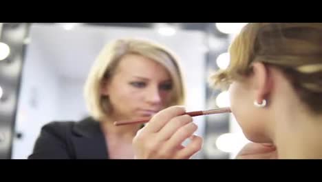Make-up-artist-applying-makeup.-Using-brushes-for-correction.-Face-sculpturing.-Shot-in-4k