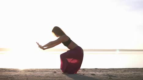Woman-in-yoga-outfit-doing-yoga-on-a-beach-and-in-front-of-the-water.-Mix-of-poses.-Yoga-pose---cobra.-Meditation.-Asana---Bhujangasana