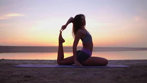 Attractive-yogi-woman-exercising-on-a-mat-near-the-sea.-Mix-ofyoga-postures.-Morning-dusk