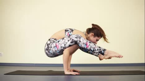 Scorpion-pose-in-yoga.-Fitness-and-wellbeing.-Young-strong-woman.