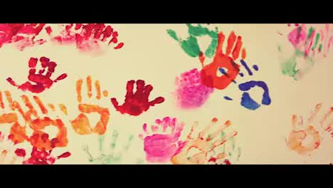 Closeup-view-of-colorful-child's-handprints-painted-on-the-wall.-4k-shot