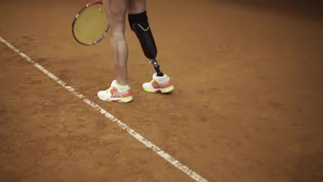 Gorgeous-slow-motion-footage-of-a-stunning-tall-woman-serving-the-ball.-Disabled-woman