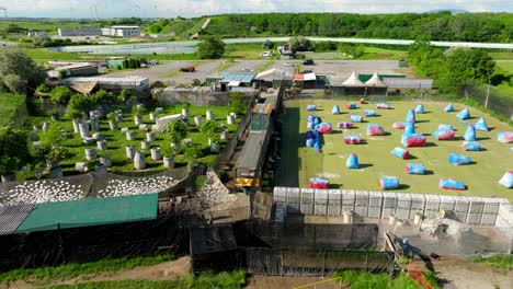 Aerial-View-Of-Paintball-Field-With-Variety-Of-Obstacles-In-Summer