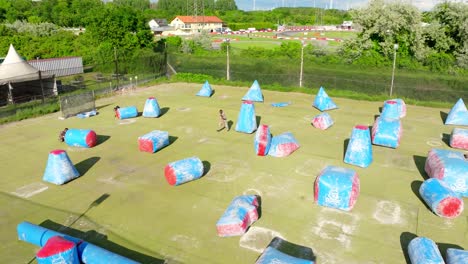 People-Playing-Paintball-At-Outdoor-Field-With-Inflatable-Bunkers-In-Austria