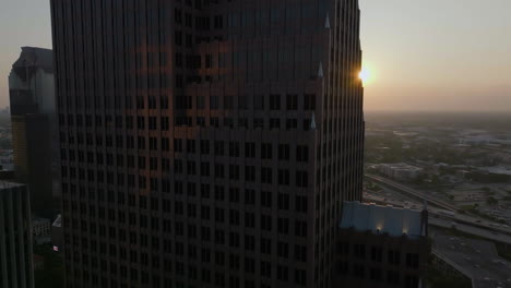 Aerial-view-tilting-in-front-of-the-TC-Energy-Center,-sunrise-in-Houston,-USA
