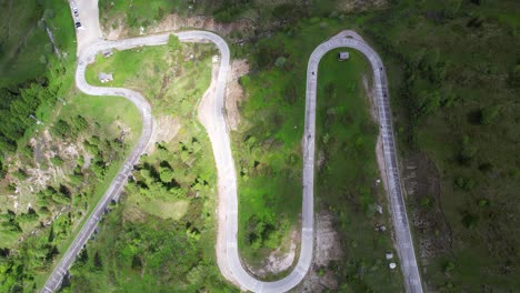Top-down-aerial-shot-of-curvy-twisted-mountain-road-in-Passo-Giau,-Italy