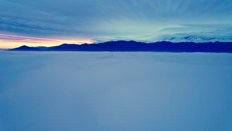 Aerial-Blue-Cloudscape-Above-Cloudy-Sky-of-Santiago,-Chile,-Blue-Golden-Sunrise,-Drone-entering-Inside-Misty-Gloom,-Colorful-Gradient