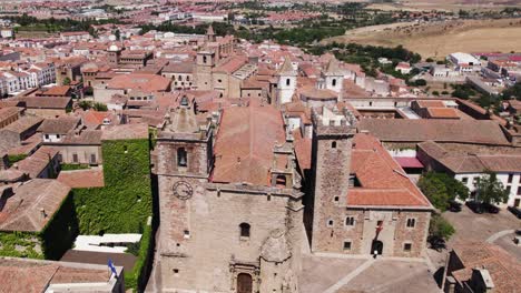 Aerial-view-orbiting-Cáceres-Iglesia-de-San-Francisco-Javier-and-San-Mateo-catholic-churches-in-colourful-Spanish-terracotta-cityscape