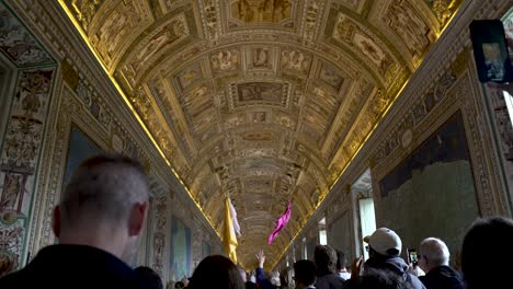 POV-Walking-Behind-Tour-Group-Sightseeing-Inside-The-Vatican-Gallery-of-Maps