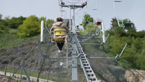 a-woman-riding-on-a-small-chair-in-a-cable-car-at-Prague-Zoo-in-the-Czech-Republic