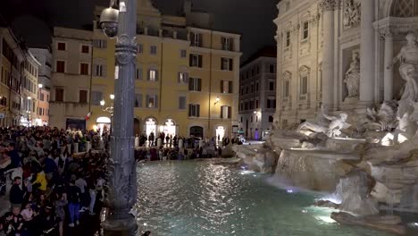 Illuminated-Trevi-Fountain-And-Crowds-In-The-Evening-Viewed-From-Via-della-Stamperia