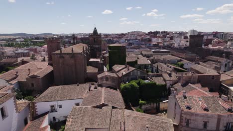 Aerial-view-orbiting-Cáceres-catholic-church-of-San-Mateo-on-colourful-Spanish-terracotta-urban-cityscape-skyline