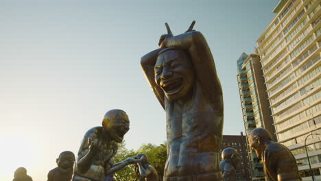 Low-Angle-Close-Up-of-A-maze-ing-Laughter-Bronze-Statue-in-Vancouver-West-End-Morton-Park---Sunset-Golden-Hour