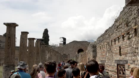 Crowds-Of-Tourists-Walking-Along-Ruins-Of-Wall-At-Quadriporticus-of-the-Theatres-In-Pompeii