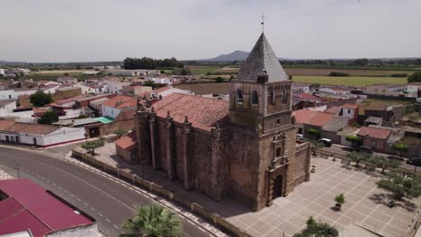 Aerial-view-orbiting-Torremayor-church-neighbourhood-with-suburban-red-rooftop-buildings-in-the-Badajoz-province