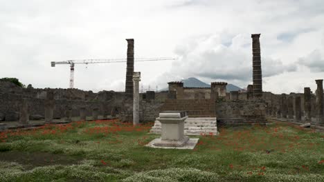 Iconic-remaining-columns-of-a-Santuario-di-Apollo-Roman-temple-dating-back-to-6th-century-BC-framing-Mount-Vesuvius-In-Pompeii