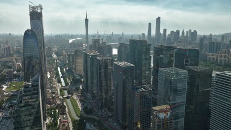 Aerial-view-overlooking-tech-buildings-in-downtown-Guangzhou-city,-sunny-China