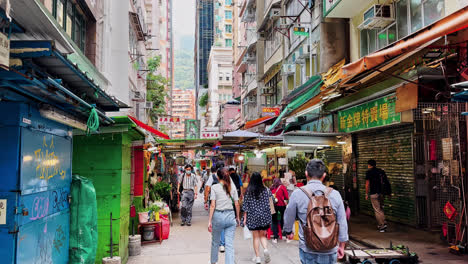 Locals-and-Tourists-Walking-on-Old-Style-Tai-Yuen-Toy-Street-in-Wan-Chai,-Hong-Kong