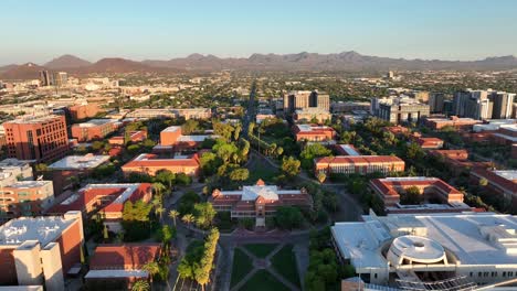 Descending-aerial-shot-of-Old-Main-building-and-lawn-on-University-of-Arizona-campus