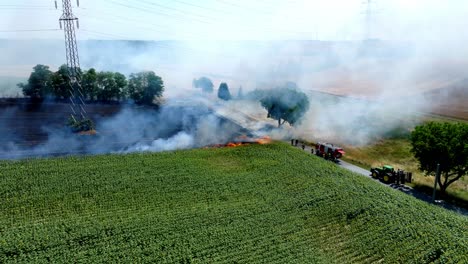 Fire-Truck-At-Burning-Field-With-Smoke---aerial-drone-shot