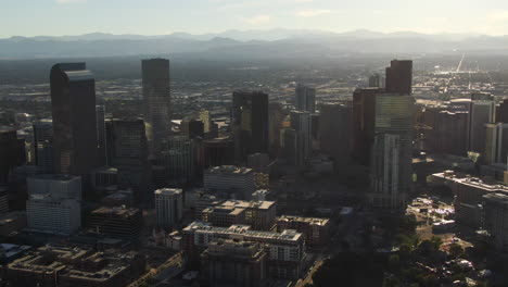 Aerial-cinematic-drone-mid-summer-early-fall-Downtown-Denver-Colorado-mile-hight-city-buildings-traffic-wisp-clouds-blue-sky-afternoon-sunset-stunning-golden-hour-light-forwards-pan-up-movement