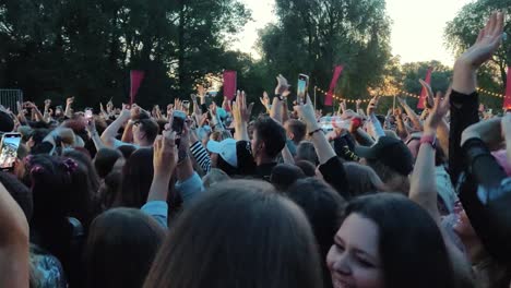 Riga,-Latvia---14-July-2023:-Unrecognizable-Fans-Dancing-Mosh-pit-and-Raising-Their-Hands-at-a-Concert-or-Festival-Party-Silhouettes-of-Crowd-Audience-Enjoying-Concert-in-Front-of-Bright-Stage-Lights