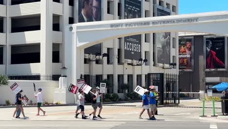 Actors-SAG-AFTRA-and-Writers-Guild-of-America-on-strike-with-signs-in-front-of-Sony-Pictures-Entertainment,-Culver-City,-Los-Angeles