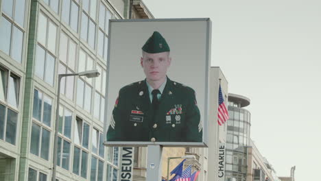 A-close-up-of-a-statue-of-a-soldier-at-Checkpoint-Charlie-in-Berlin,-a-significant-monument-from-the-Second-World-War