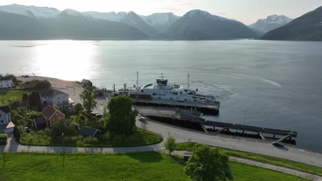 Electric-ferry-Dragsvik-alongside-sognefjord-Norway---Stunning-sunset-aerial-with-fjord-and-mountains-in-background