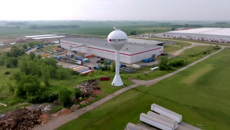West-Branch,-Iowa-water-tower-with-drone-video-pulling-back